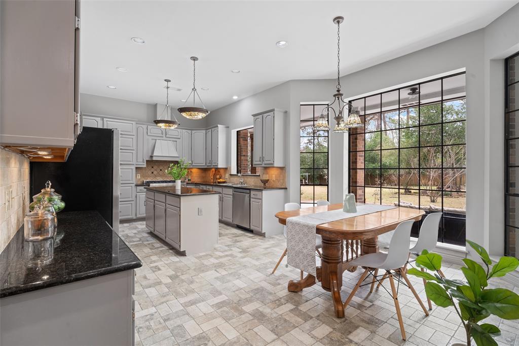 The kitchen and breakfast room offer stunning views of the spacious backyard and lush greenery.