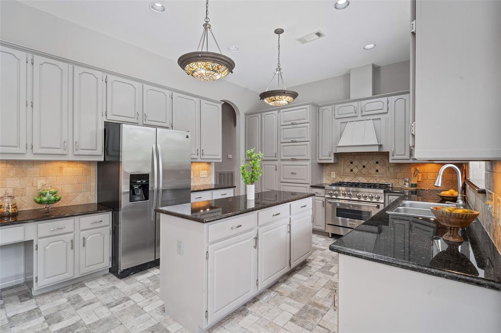 This kitchen is spacious, well-lit, and offers ample storage space.