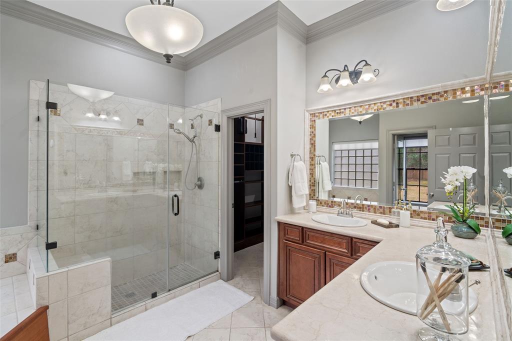 The primary ensuite features a spacious shower with double sinks.