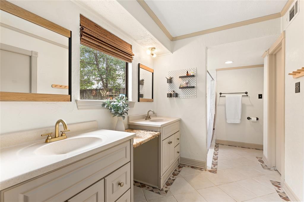 Primary bathroom featuring dual vanities, new shower tile 2020, and 2 walk-in closets