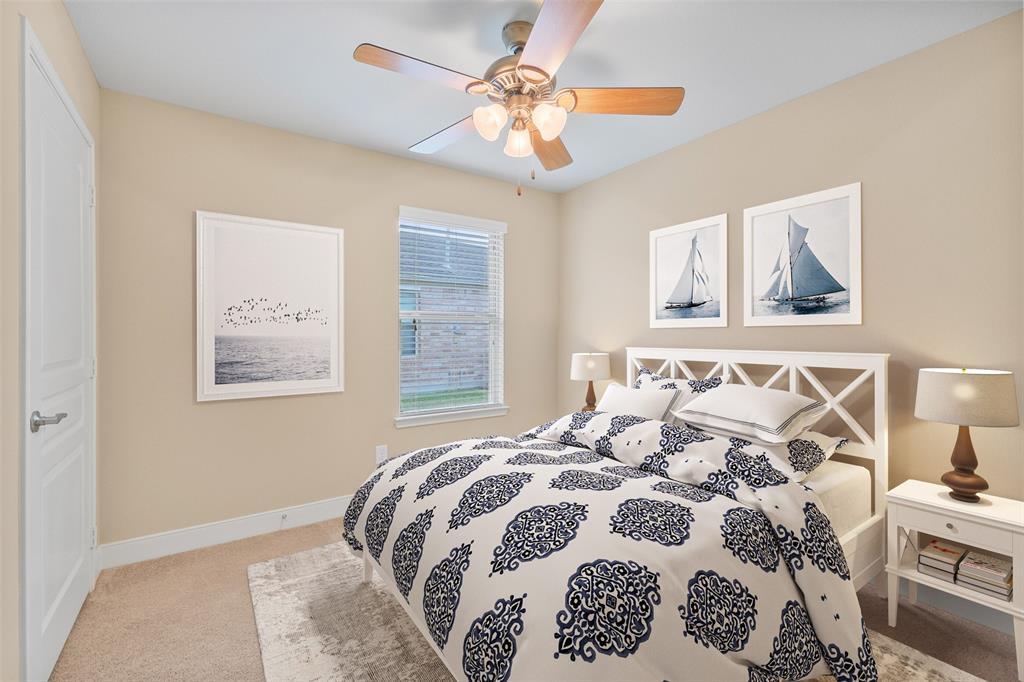 CHARMING BEDROOM 3 OFFERS A CEILING FAN AND DUAL WINDOWS.