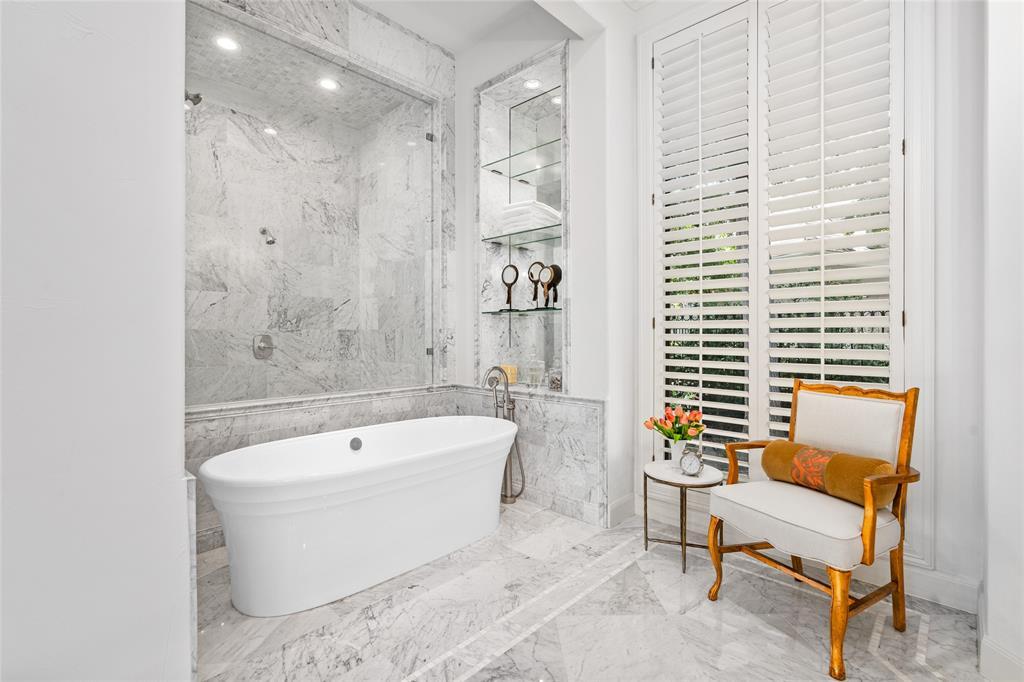 The soaking tub has its own alcove just outside the large shower.