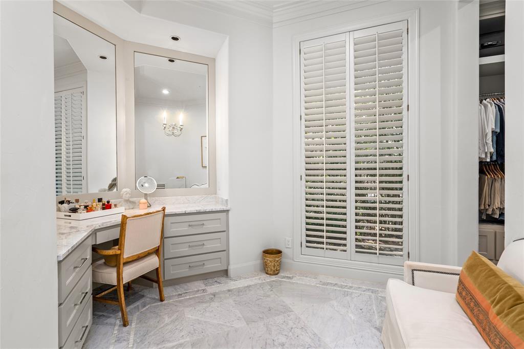 The elegant marble floors and countertops carry into the dressing room.