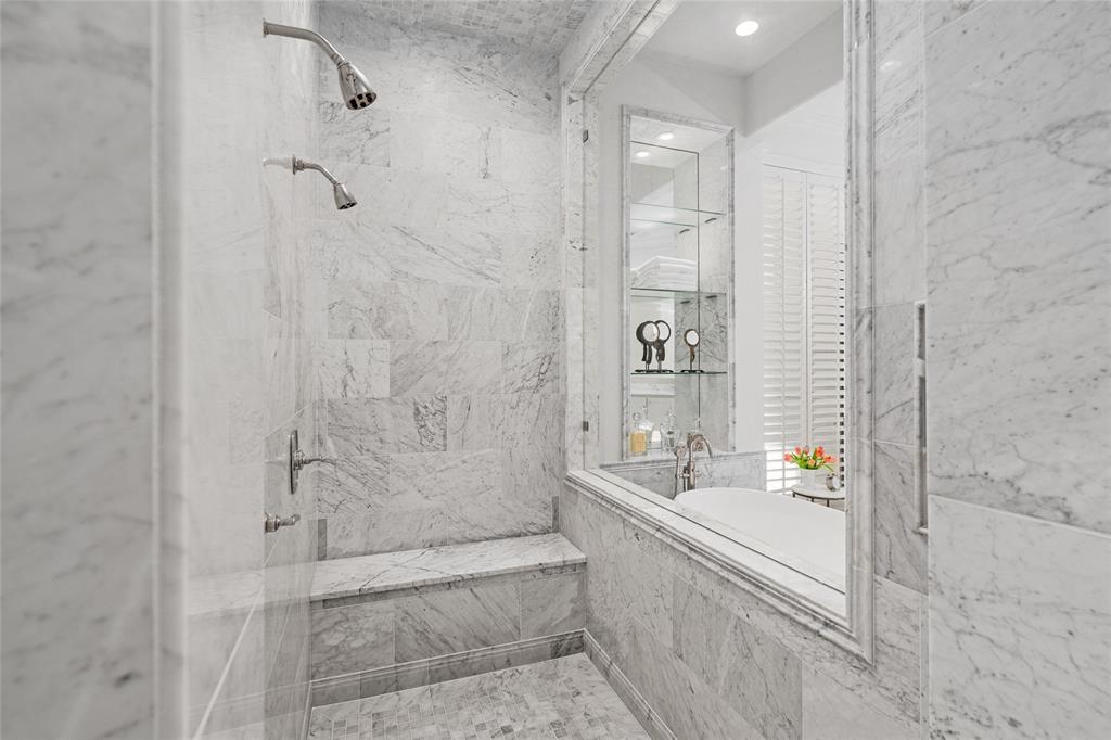 A large walk-in shower with dual shower heads.
