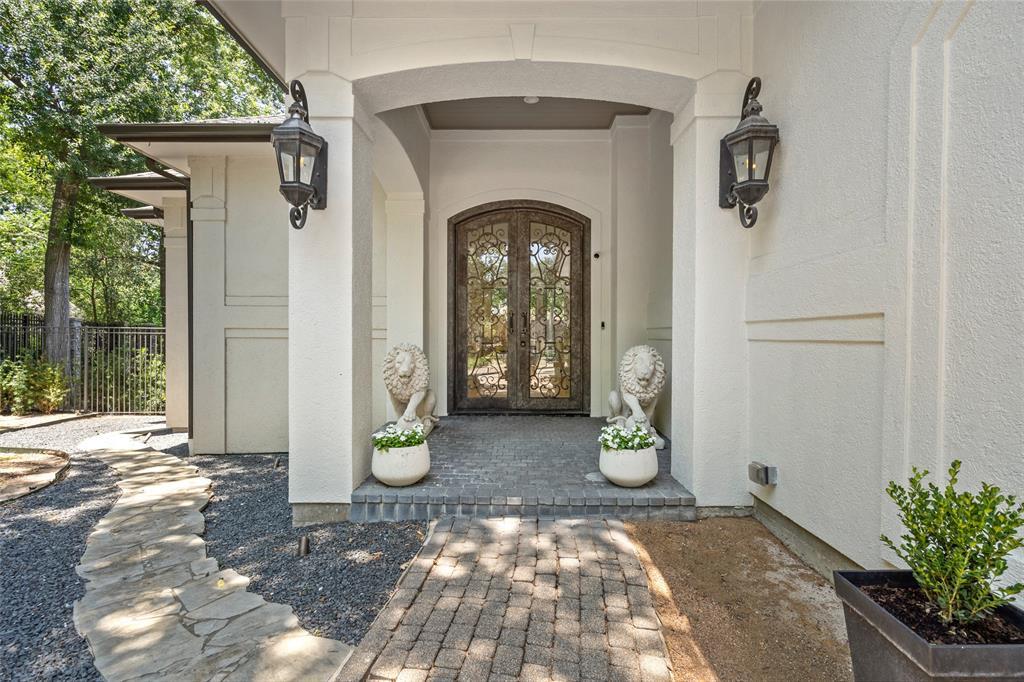Be welcomed into this spectacular property through this impressive entryway with iron and glass front doors.