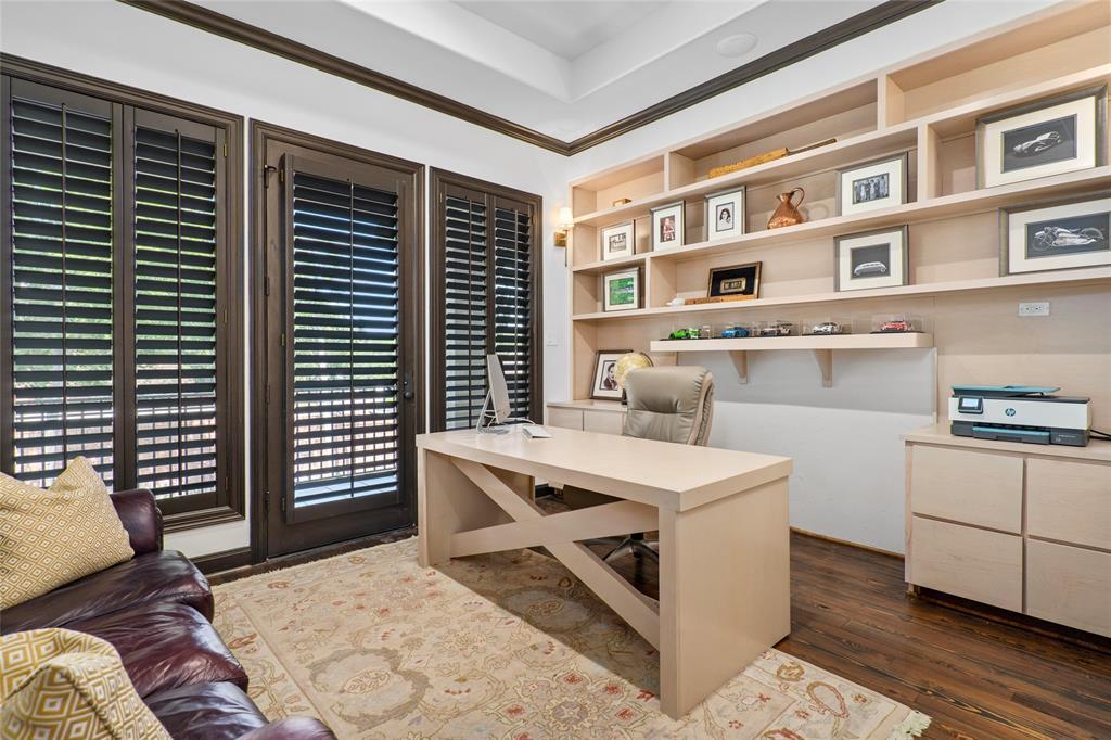 A beautiful and functional home office with access to the balcony overlooking the pool and backyard.