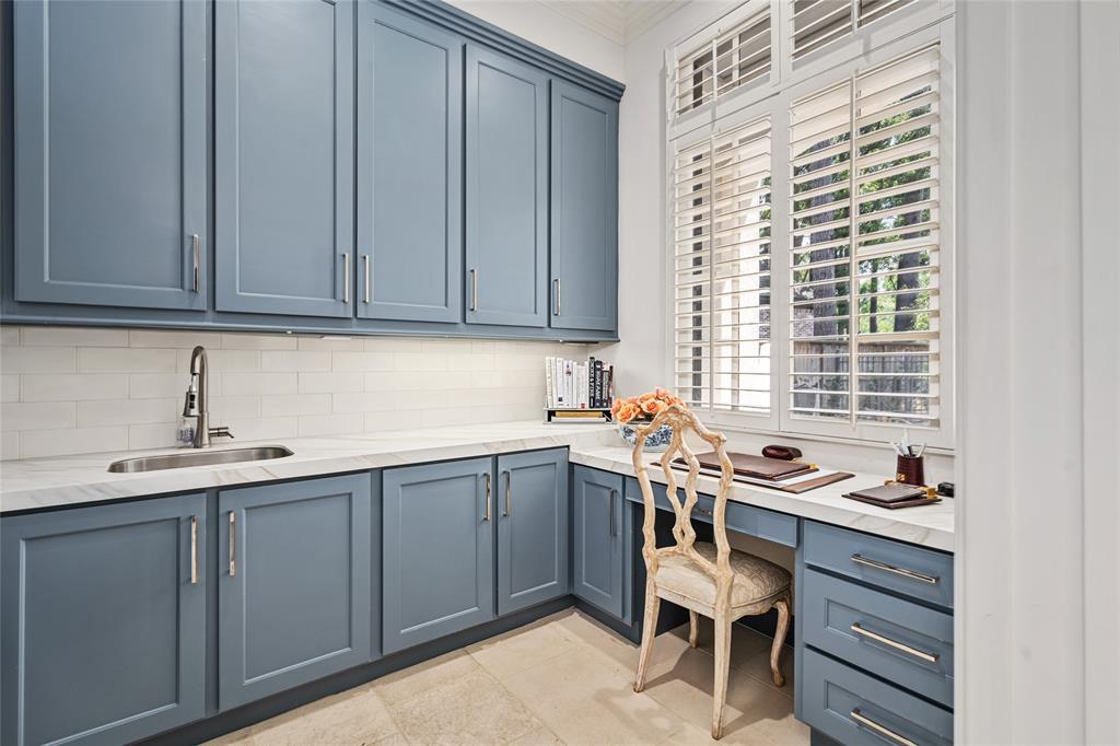 The spacious utility room off the kitchen is highlighted by the cozy and functional work area.