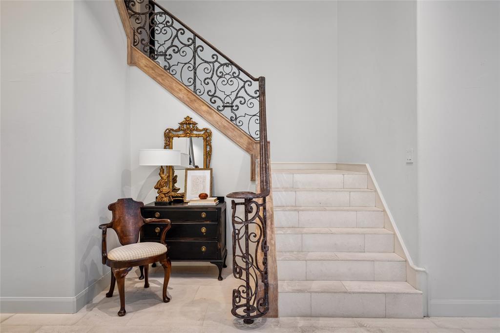 Limestone stairs and an elegant wrought iron banister lead to the second floor.