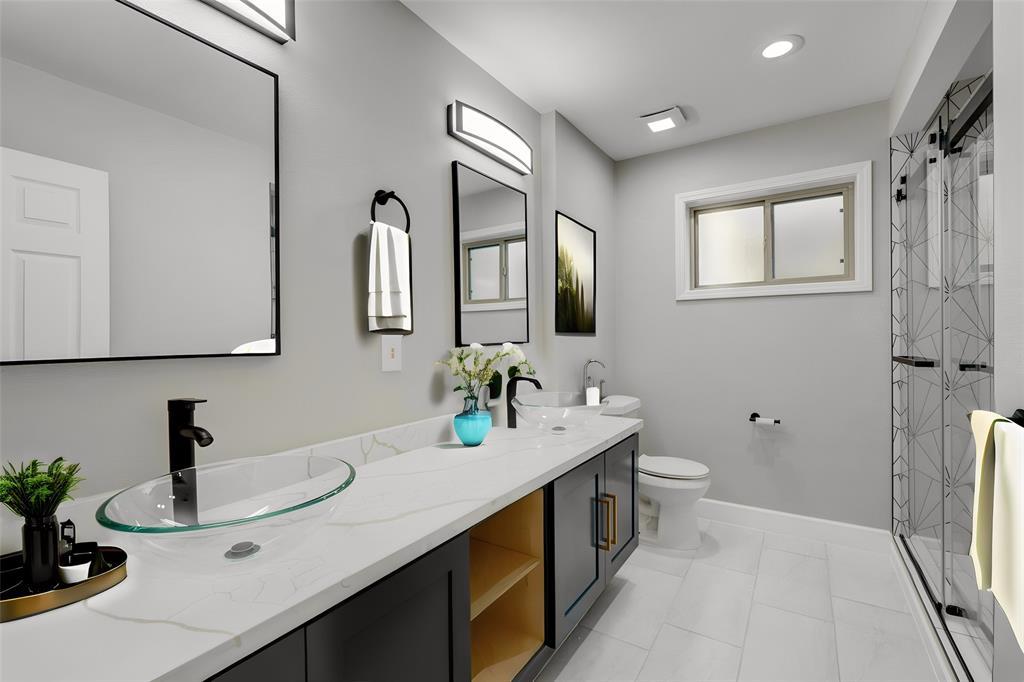 The guest bathroom offers a lavish experience mirroring the primary bathroom's style. *Photo virtually staged to show potential*