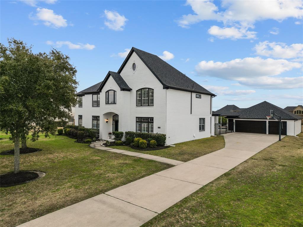 Long driveway, detached 3 car garage that is extra wide and long. Plenty of room for 3 cars plus workout room, golf cart, fridge, freezer and more!