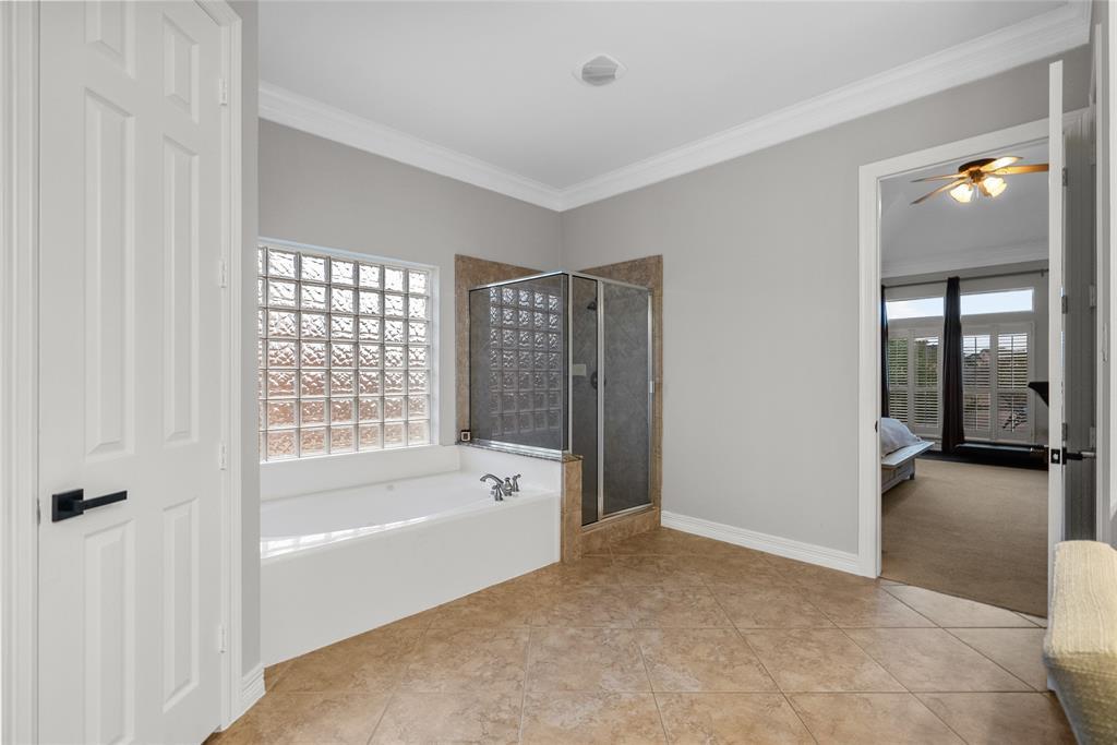 Primary bathroom with tub and seperate shower, huge closet off the bathroom in addition to linen closet in front of the shower
