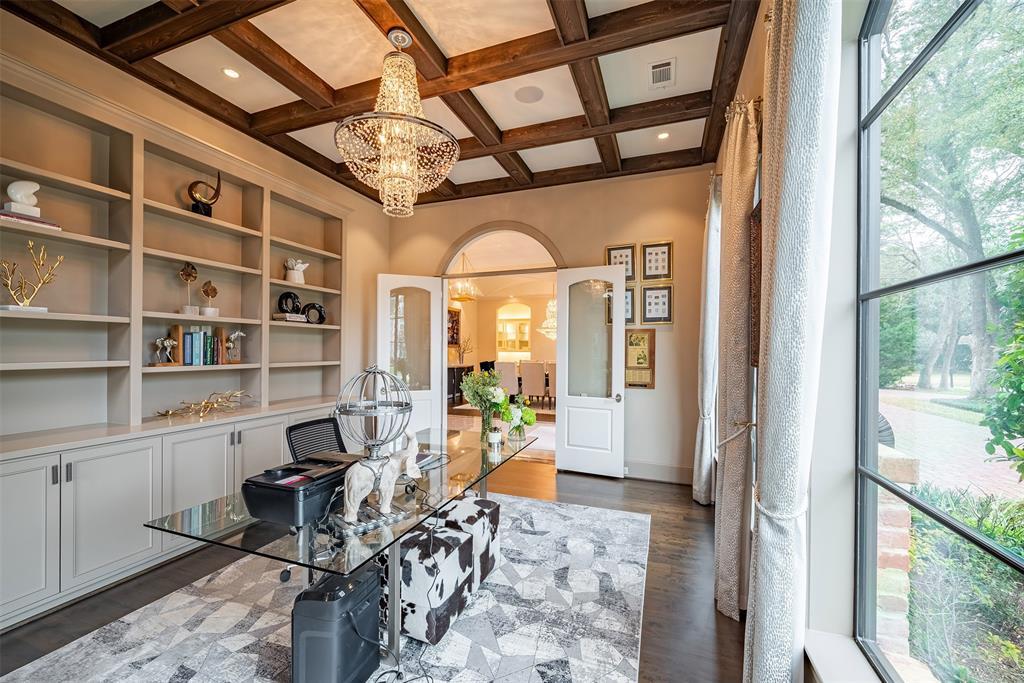 To the right from the foyer is your formal dining room with large windows and stunning chandeliers. The detailed archs off the ceiling provide such architecture flair and elegance.