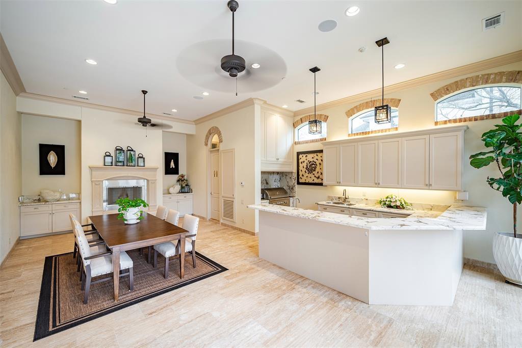 Another view of the indoor/outdoor kitchen area is air conditioning; features a full bath for those hot summer swimming days. What a great bonus and feature to this beautiful estate!