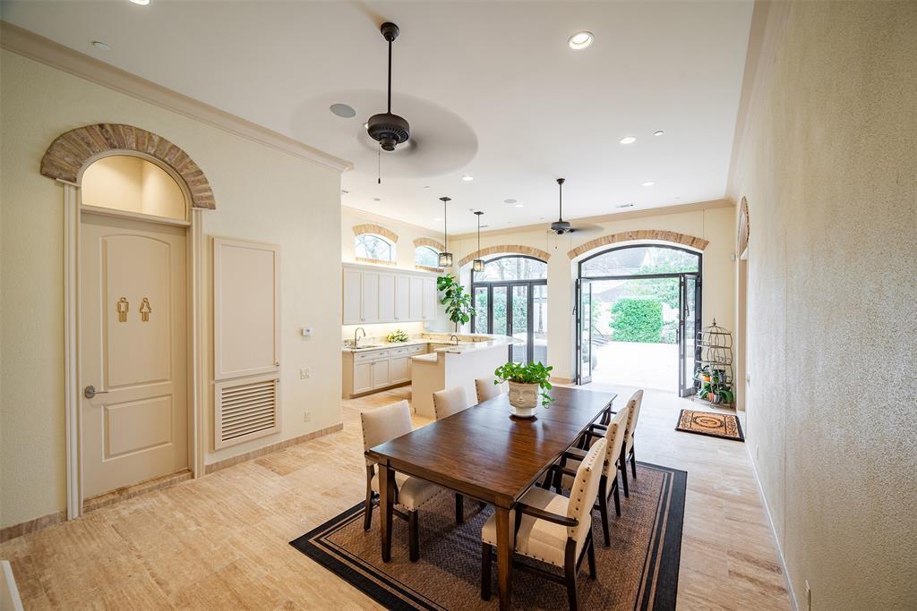 The indoor/outdoor kitchen with was thoughtfully designed and built for the upmost comfort and convenience; thru the double iron doors that lead out to the lounging, pool area. This space feature a large grill, granite counter tops, ice maker, wine cooler, recessed lighting, speakers.