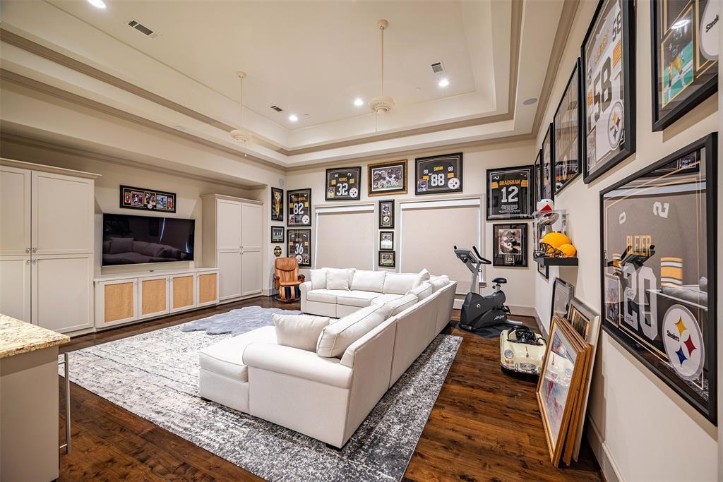 The grand game/media room features large space with double large window & remote control shades; recessed lighting, tray ceiling and plenty of room for those game nights.