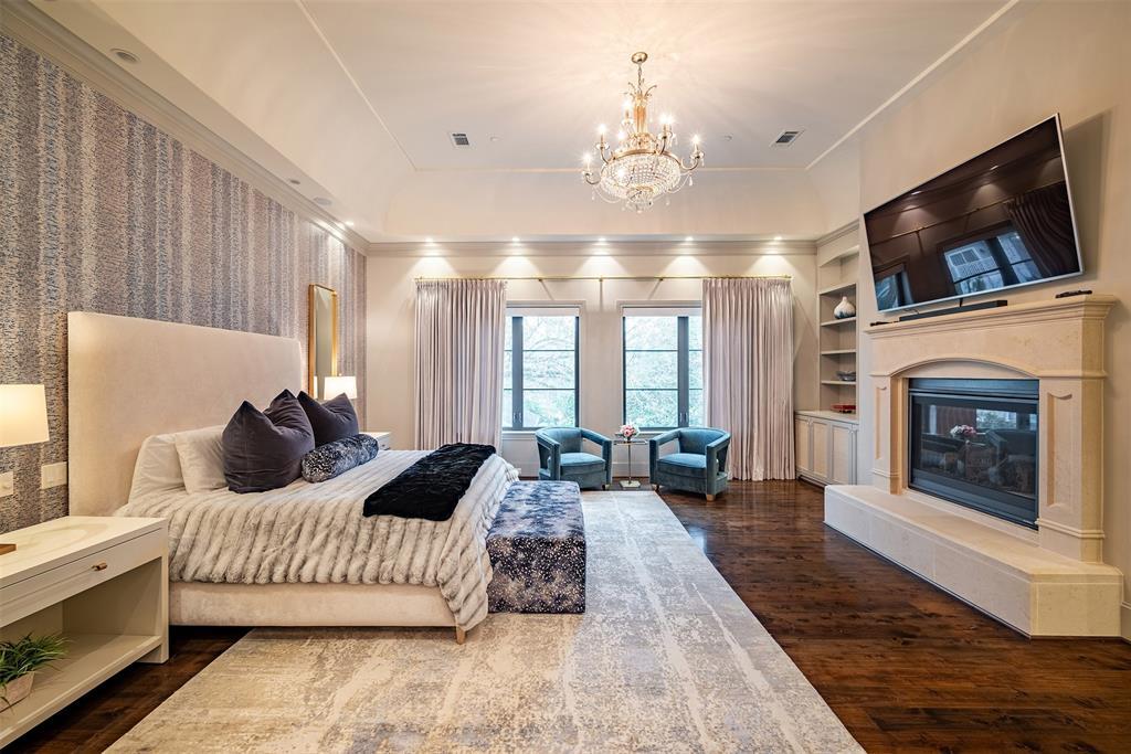 The stunning, luxurious, grand primary suite located on second floor feature beautiful cast stone fireplace, large double windows for lots of nature sunlight, custom window treatments and motorized shades.