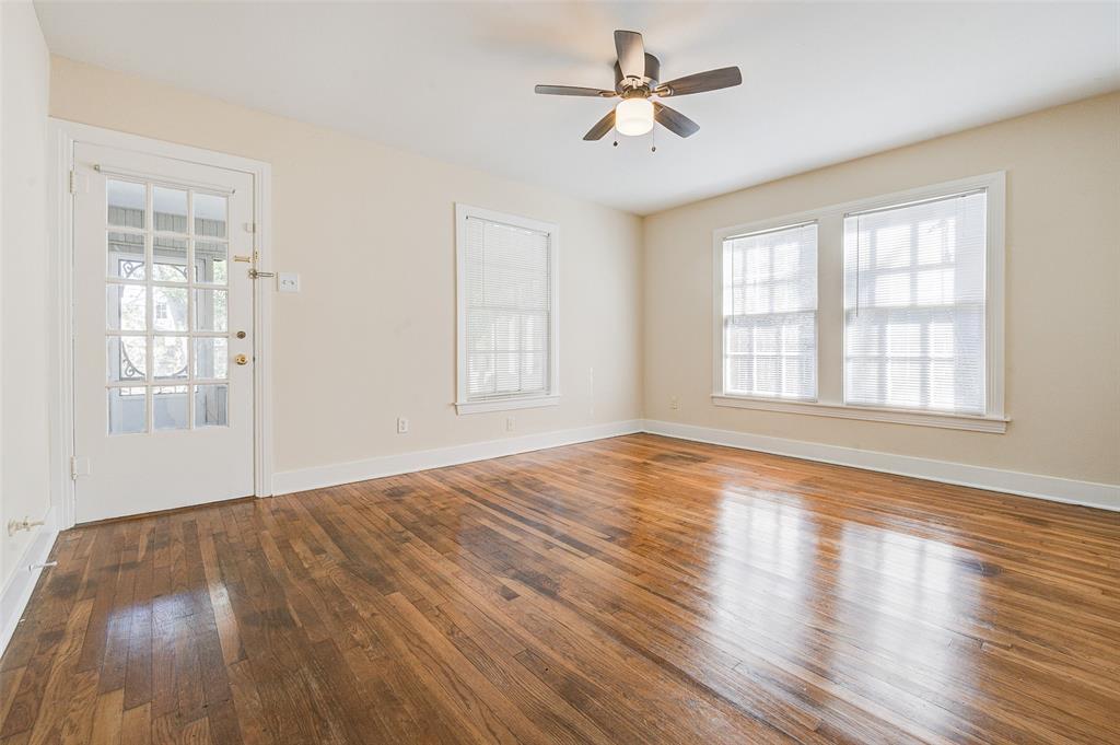 Spacious back bedroom with an abundance of natural light and door to screened-in porch.