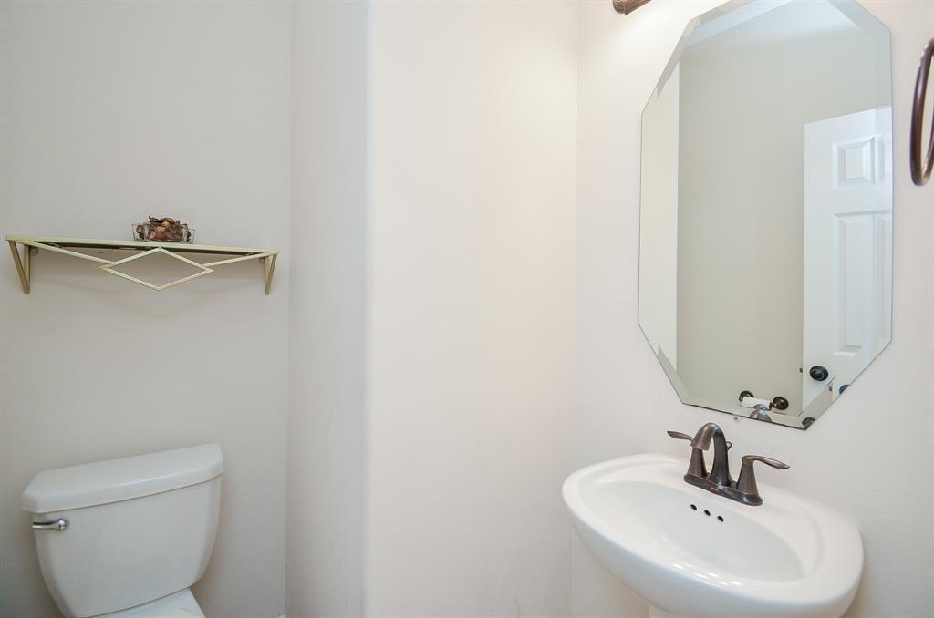 This darling petite sink and geometric mirror above add personality to the half-bath