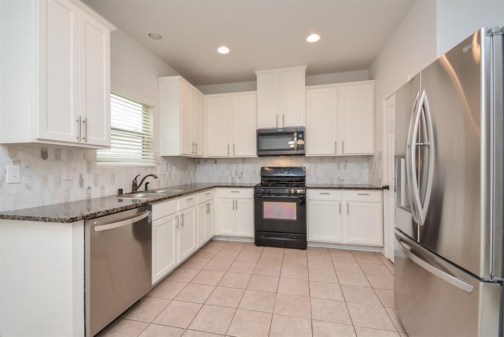 Creamy white cabinetry fills every inch of space, up and down; with earth toned granite countertops, recently UPDATED marble backsplash, and shining stainless steel appliances. LG Fridge will convey!