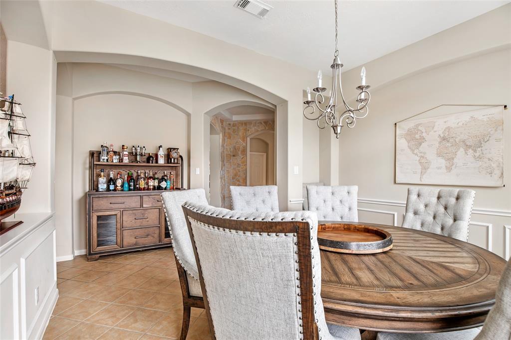 This Formal Dining area, has added counter space, and plenty of space for a Fully stocked Wet-Bar with room to spare for entertaining guests.