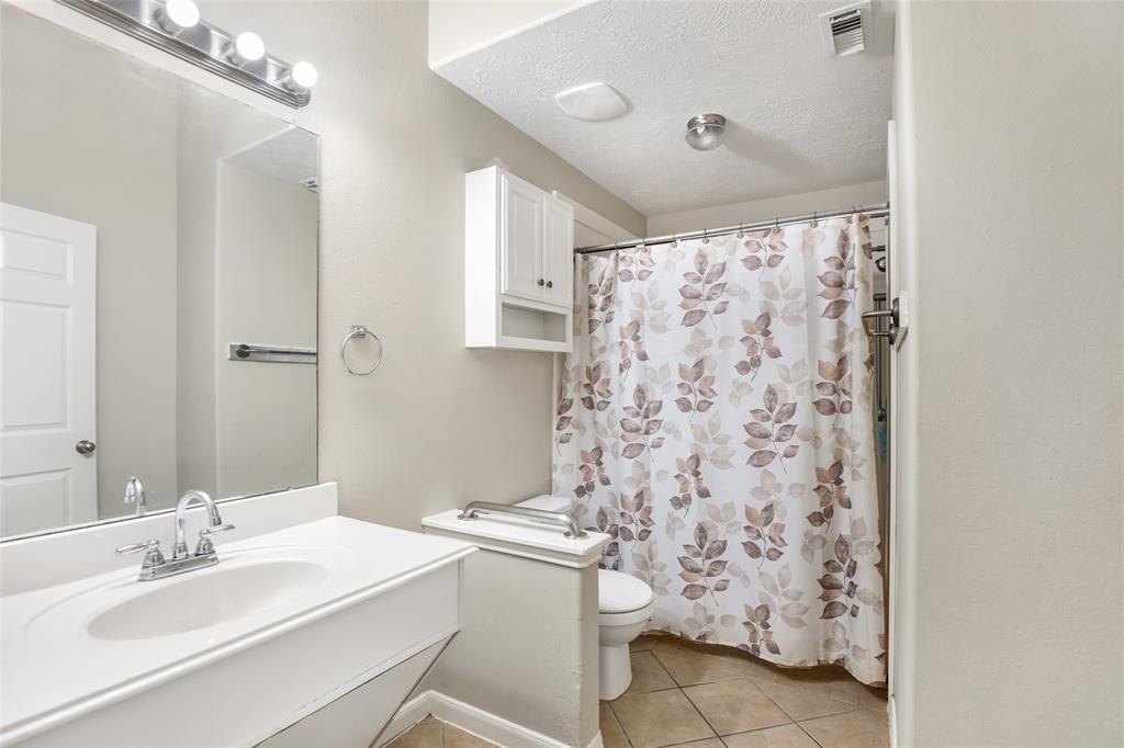 Full Bathroom #1, equipped with Wheelchair Accessibility throughout, notice railing for added restroom safety.