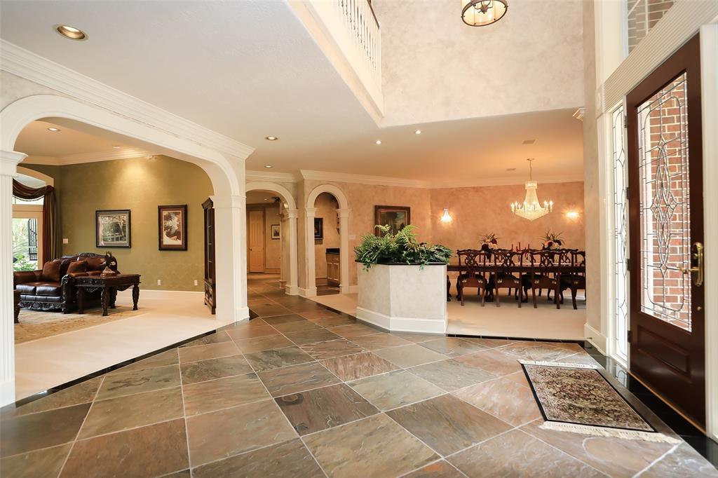 Once inside the large foyer, the custom slate tile gracefully guides you to the formal living room, formal dining room, study, master suite wing, and the large family living areas.