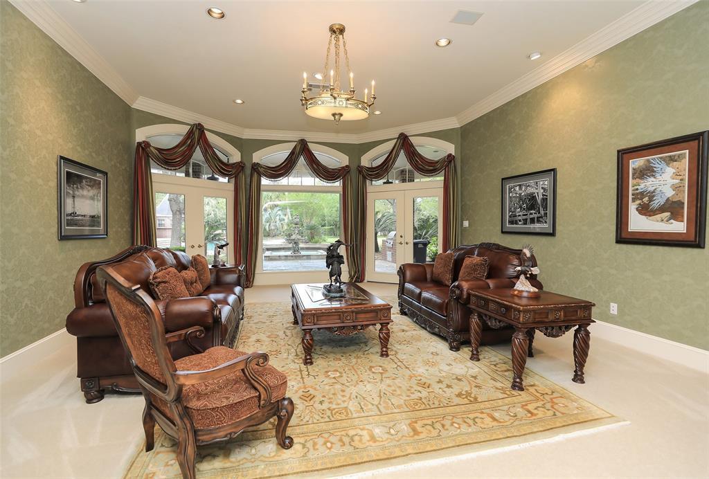 The formal living room is a very generous space with lovely views out to the fountain and pool beyond.