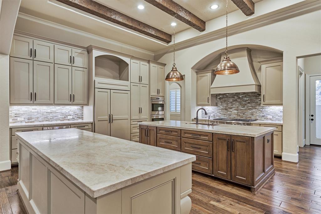 Boasting of every modern luxury for the inspired home chef, this dream kitchen has it all! Stylish illuminating light fixtures, a 6-burner gas cooktop, double ovens, gorgeous granite countertops, an abundance of storage and so much more.