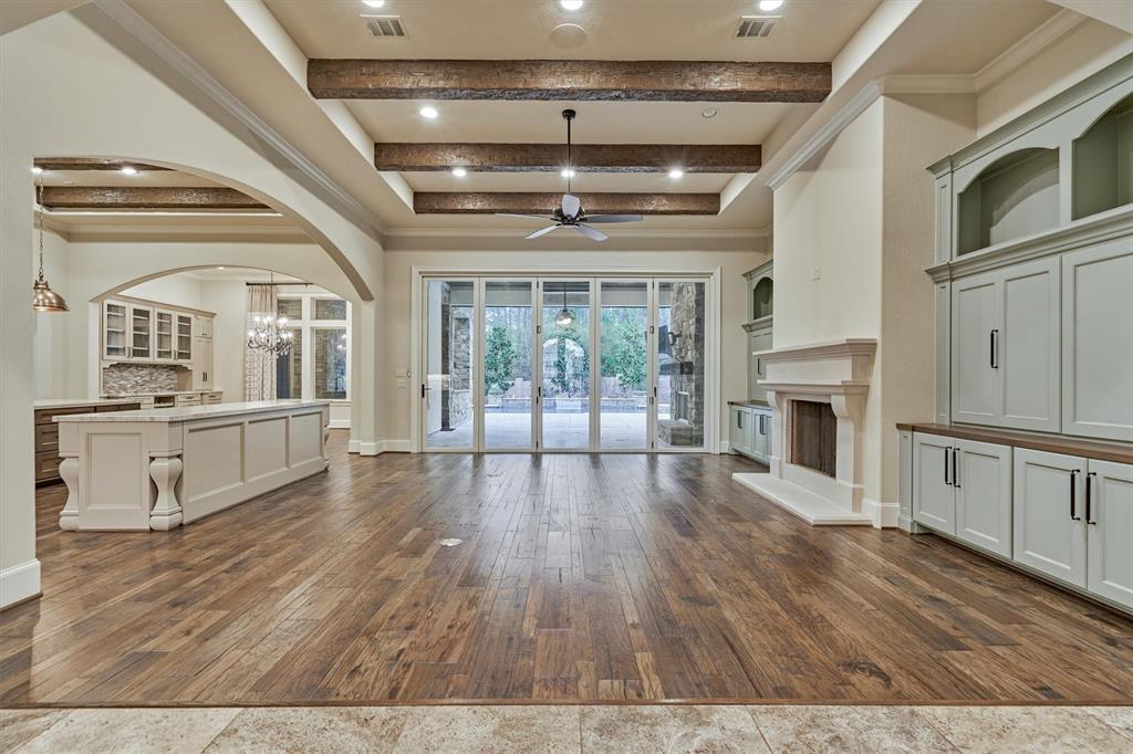 The main living area offers hard wood flooring, soaring 12 foot beamed ceilings and custom cabinetry.