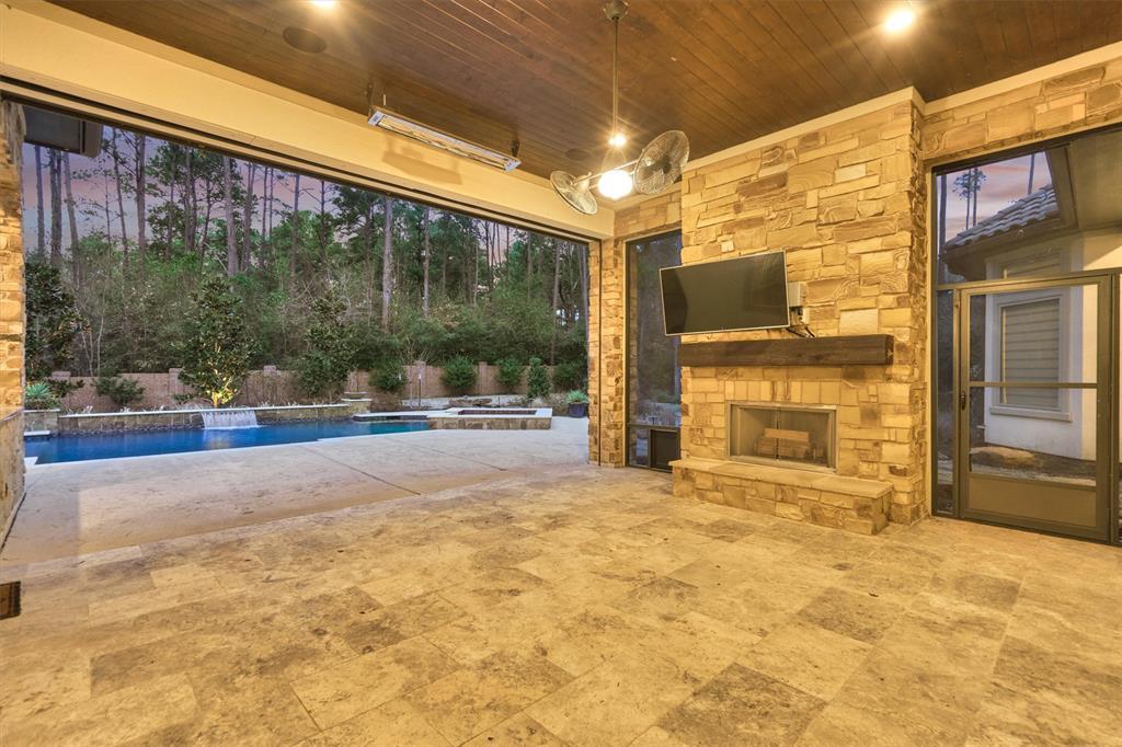 The back patio is well-suited for entertaining family and friends while the fireplace provides a cozy ambiance during the cooler months.