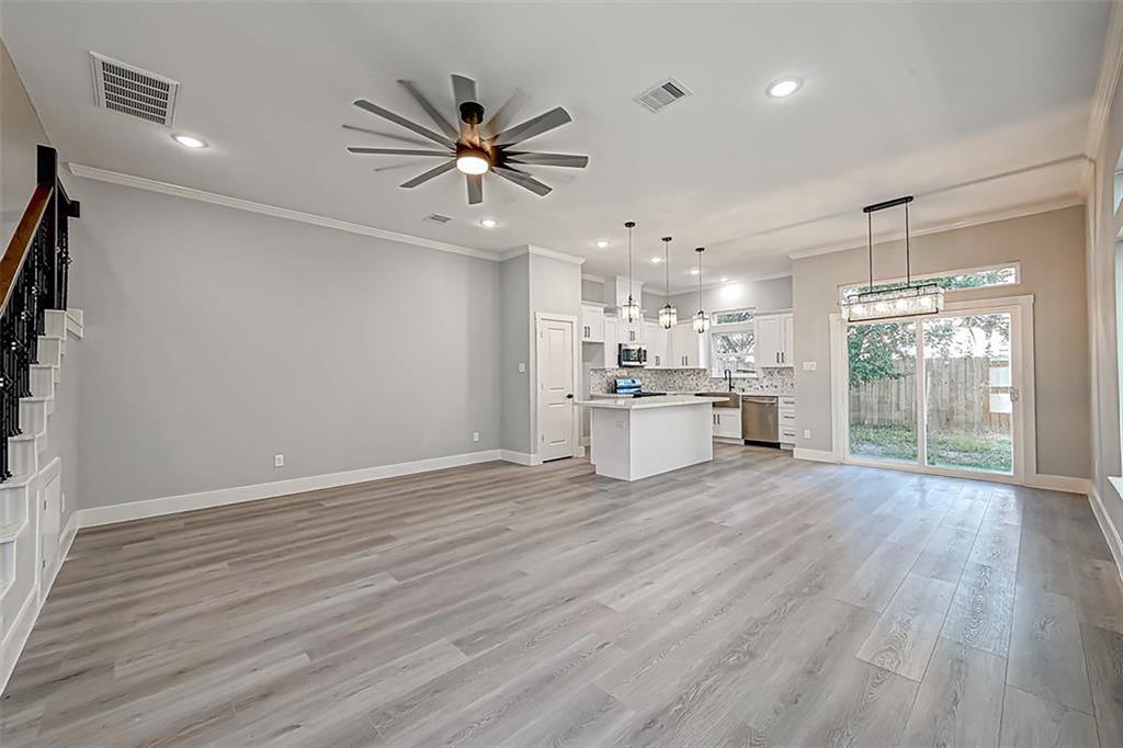 The entry door leads to an open-concept living space, inviting you and all your guests. Interior photos are from another community by the same builder; finishes and selection may vary.
