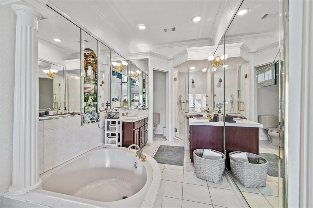 Fabulous primary bathroom with tile flooring, double sinks, and a fantastic soaker tub.