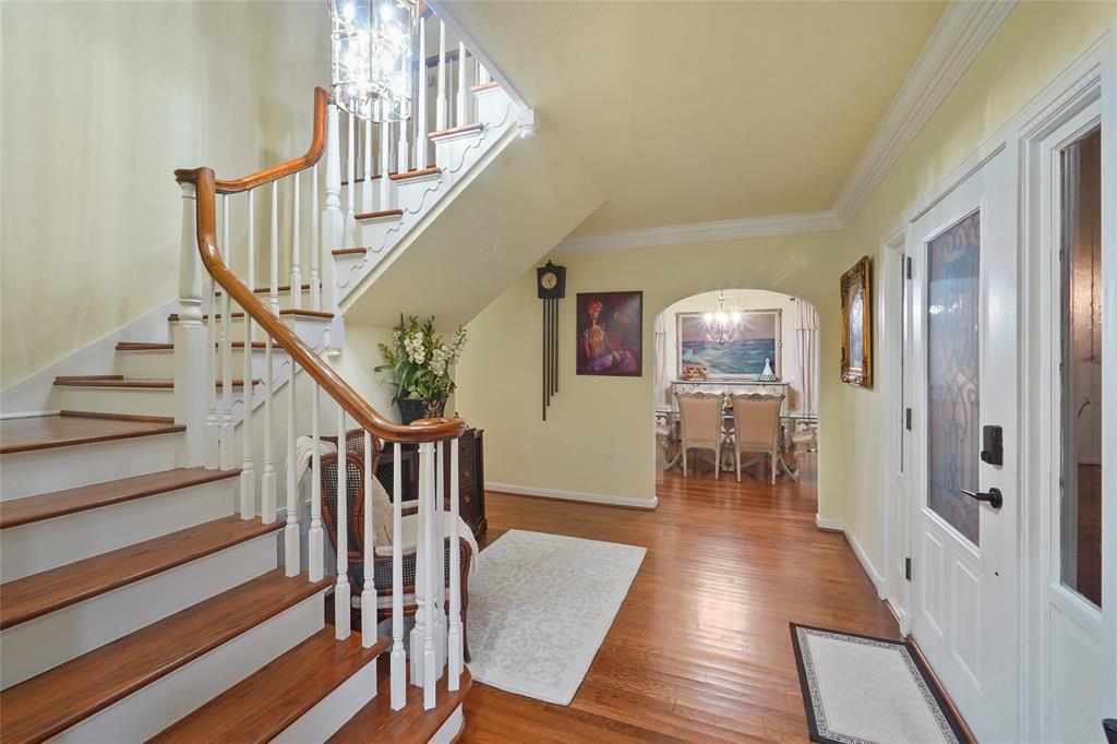 Foyer – view 2 – the wide staircase with 2 landings is accentuated by original woodwork and offers refinished period oak treads.  Wide cased opening (middle of photo) leads to the formal Dining Room. Note the double crown molding, interior walls and trim were recently repainted as well