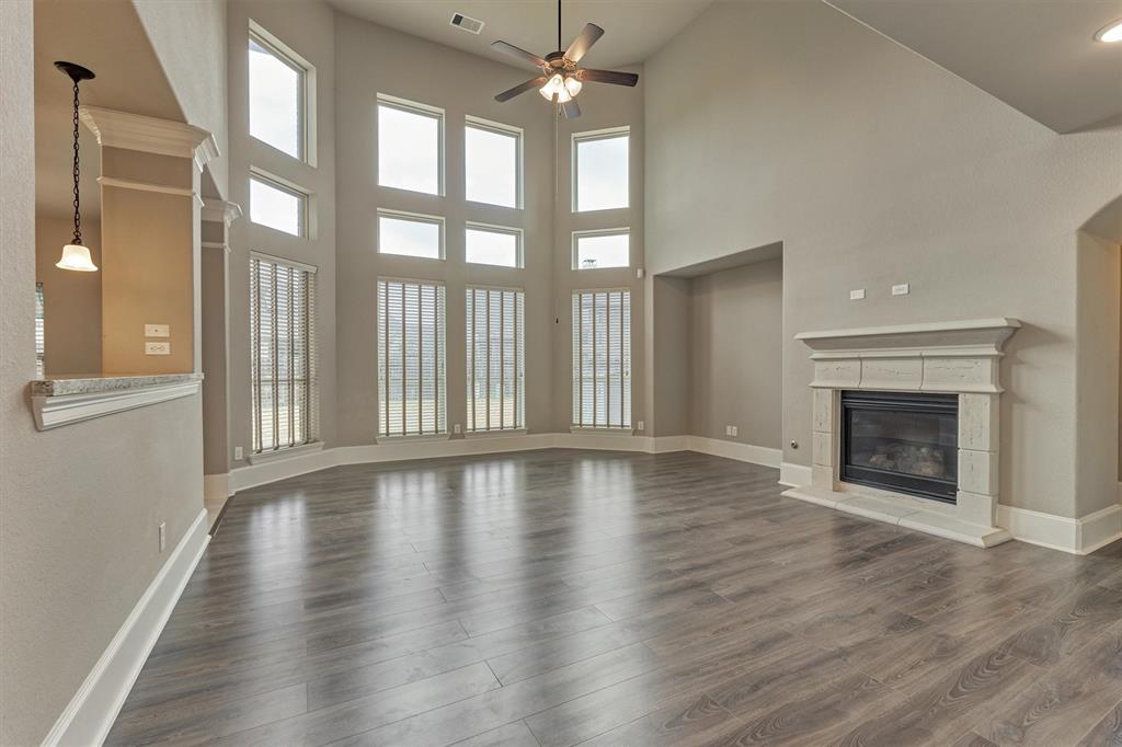 Welcoming family room overlooks the sprawling backyard and features gas log fireplace.