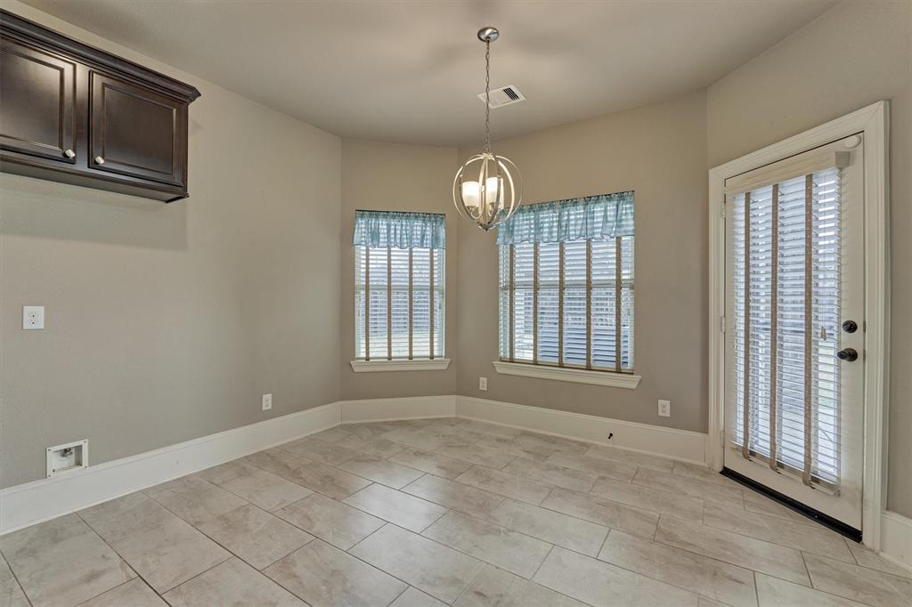 Light and bright, this sizeable breakfast room is perfect for morning coffee and meals together!  Convenient access to the rear patio for grilling!