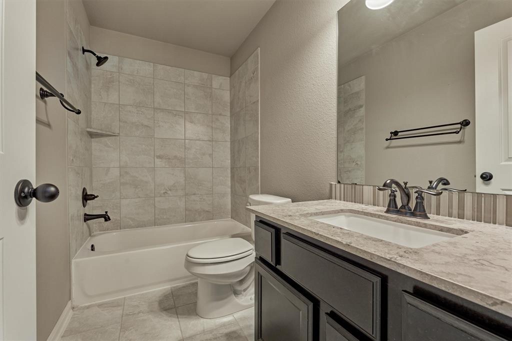 Full bath upstairs adjacent to Bedroom 2 and the Game Room. Soothing neutral palette with coordinating fixtures.