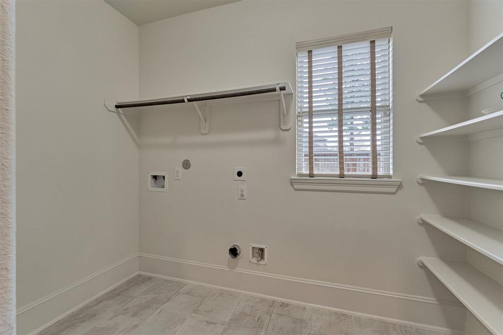Large utility room with bonus shelves/hanging space for storage and organization.