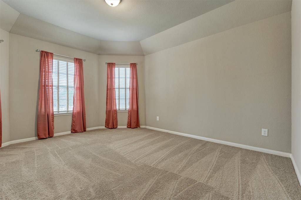 Spacious guest room features angled tray ceiling.