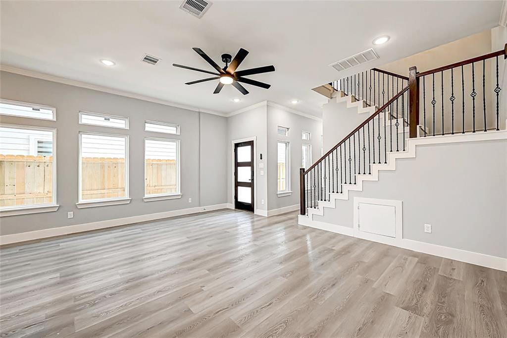 The entry door leads to an open concept living space. Interior photos are from another community by the same builder; finishes and selection may vary.