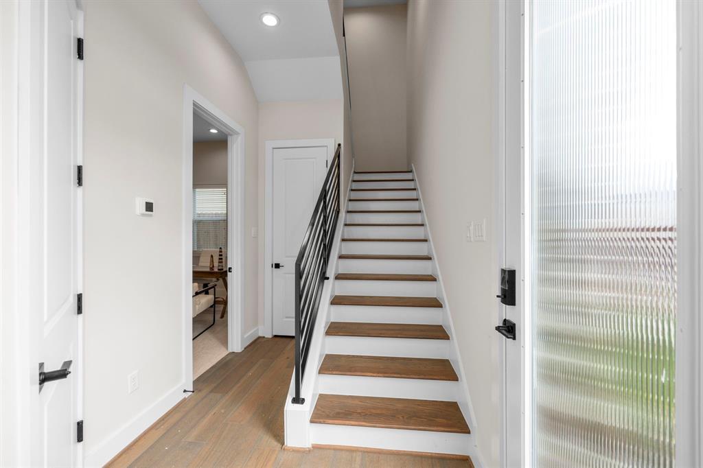 Wide Staircase and Entrance to First Floor Bedroom and Private Full Bathroom on Left-Hand Side