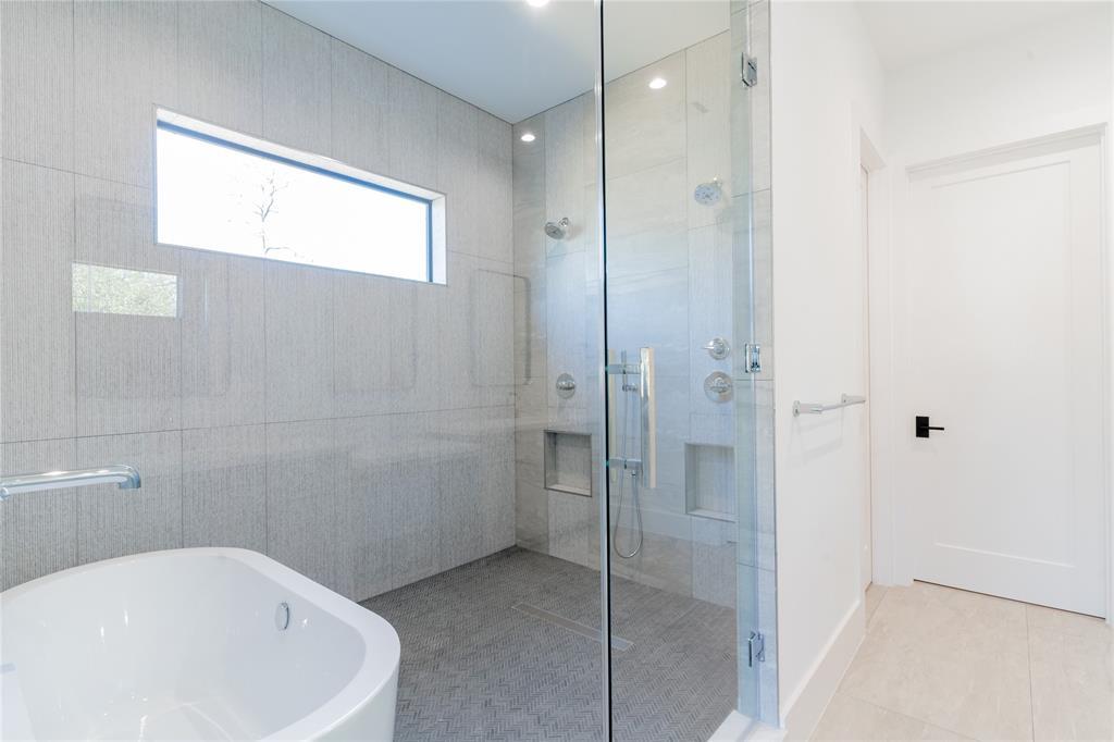 This space is large enough for a soaker tub and a shower with two showeheads.