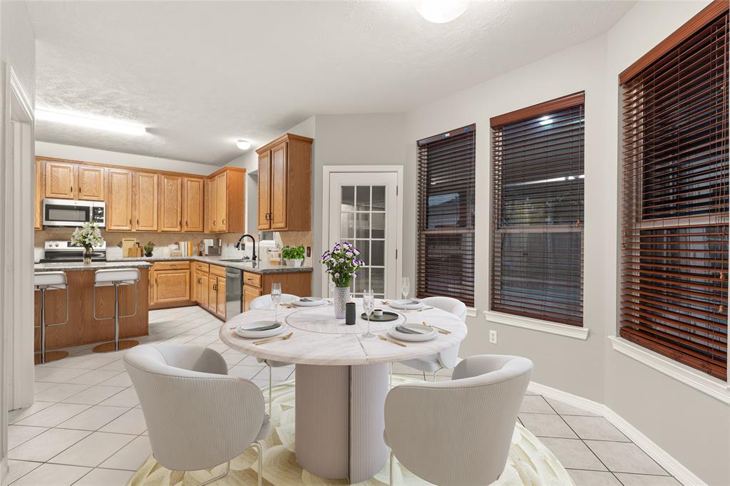 Start your day off right with a cup of coffee sitting with your family in the lovely breakfast area! Featuring large windows with blinds, custom neutral paint, tile flooring and high ceilings.
