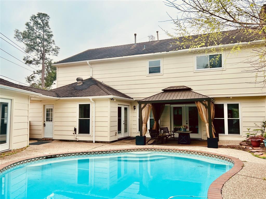 The back yard is low maintenance. A lovely and sparkling pool will welcome you.