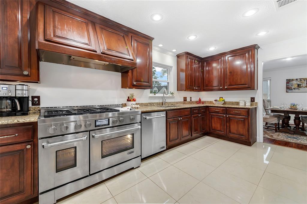 Granite counters, tons of cabinets, built in side by side refrigerator, built in microwave, and a large pantry. The kitchen opens to the formal dining room.