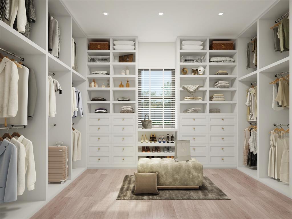 Monstrous walk in closet with top to bottom built-ins and hanging space for all of your fashion essentials!