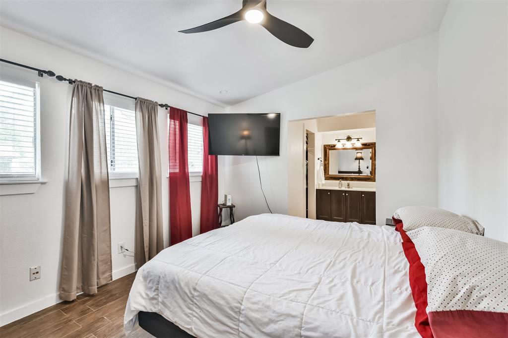 The generous sized primary bedroom is located at the front of the home and features ceramic flooring and high ceilings.